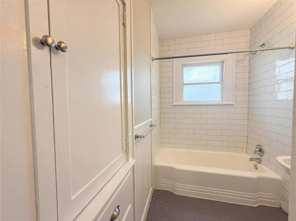 a bathroom with a bathtub and shower