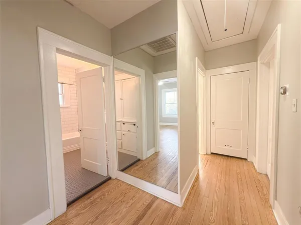 a view of a hallway with wooden floor
