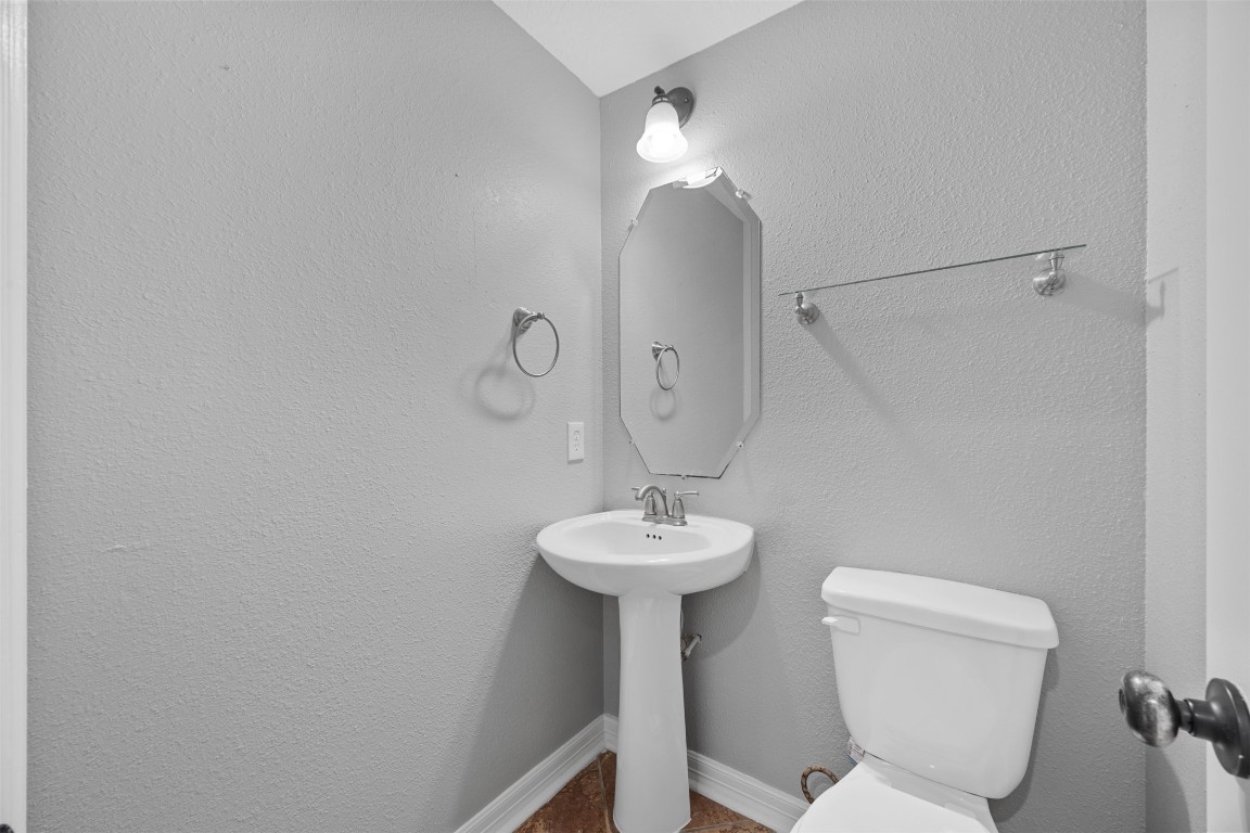 2622 Muegge Road Rosenberg, TX 77471 - Photo 16 of 35 a bathroom with a sink a toilet and a mirror