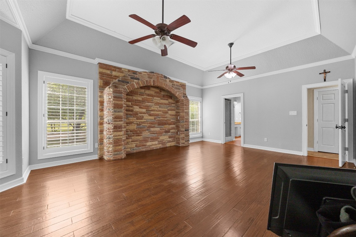 2622 Muegge Road Rosenberg, TX 77471 - Photo 20 of 35 an empty room with wooden floor ceiling fan and windows
