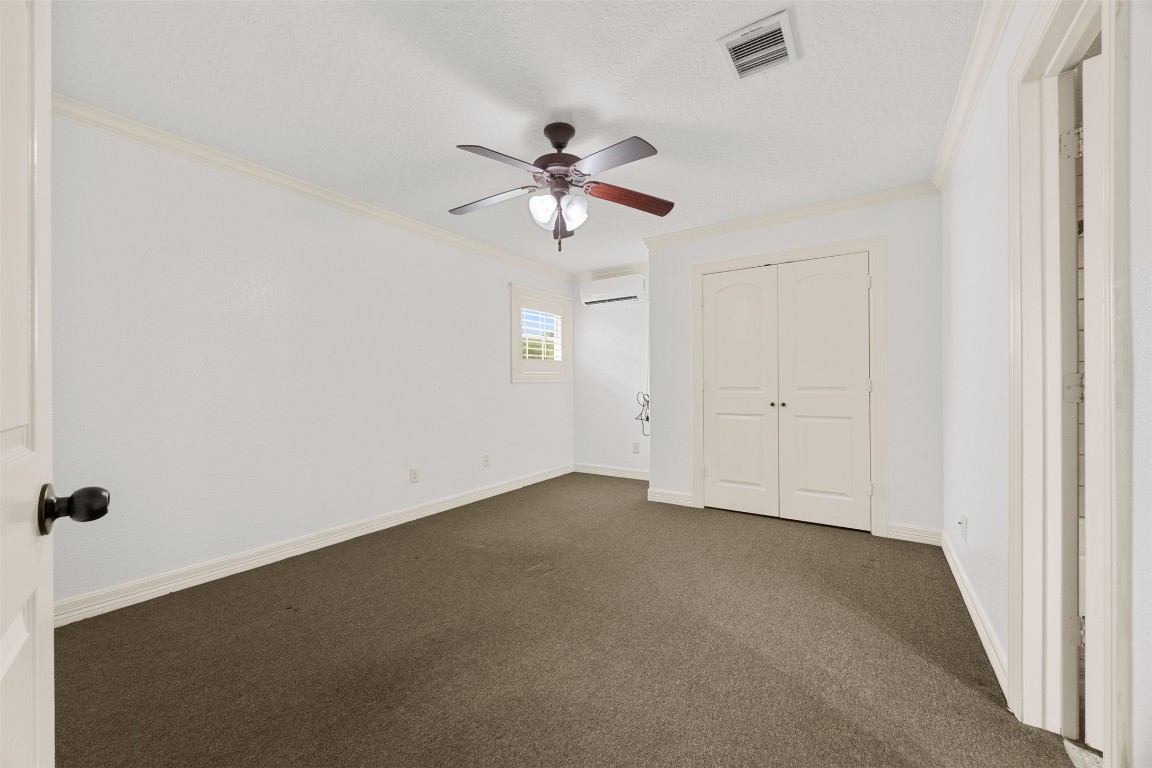2622 Muegge Road Rosenberg, TX 77471 - Photo 25 of 35 an empty room with a window and a ceiling fan