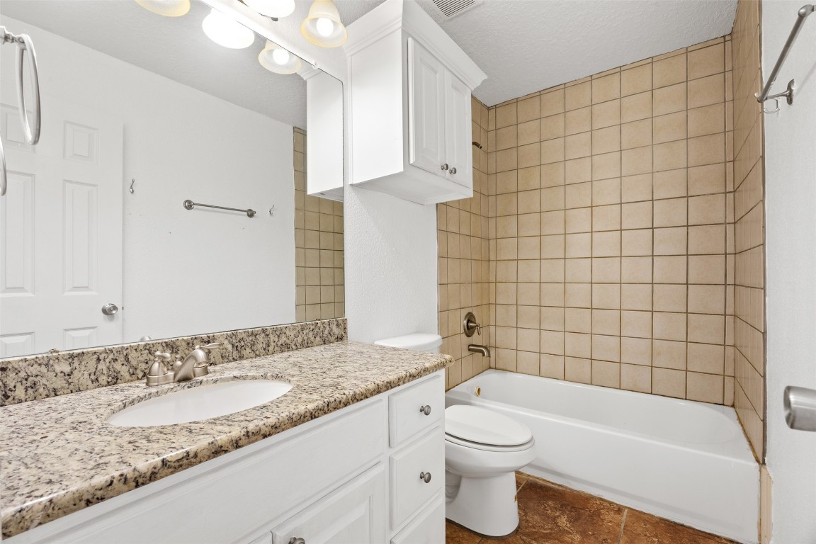 2622 Muegge Road Rosenberg, TX 77471 - Photo 28 of 35 a bathroom with a granite countertop bathtub sink vanity mirror and toilet