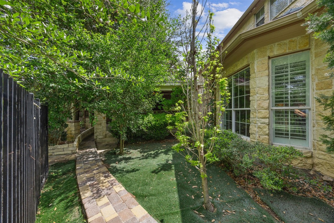 2622 Muegge Road Rosenberg, TX 77471 - Photo 3 of 35 a view of a backyard with potted plants and large trees
