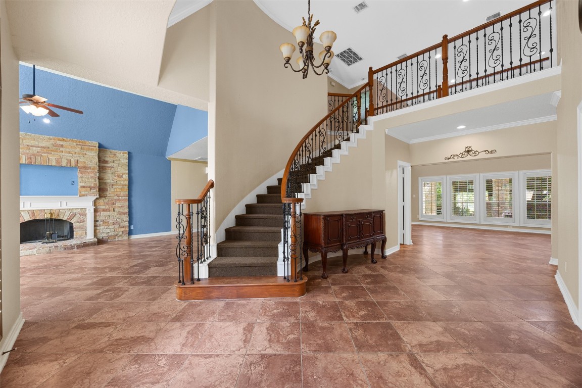 2622 Muegge Road Rosenberg, TX 77471 - Photo 6 of 35 a view of staircase with lots of frames and couches