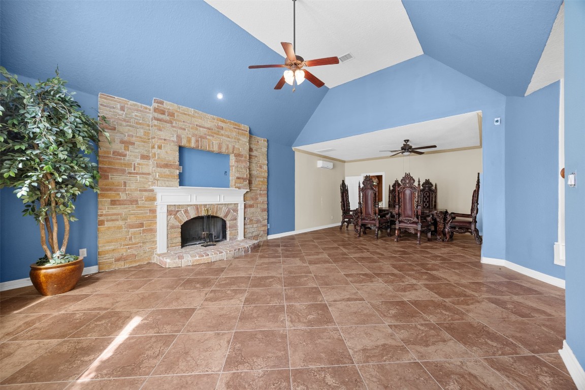 2622 Muegge Road Rosenberg, TX 77471 - Photo 8 of 35 a view of a livingroom with a fireplace and a chandelier fan
