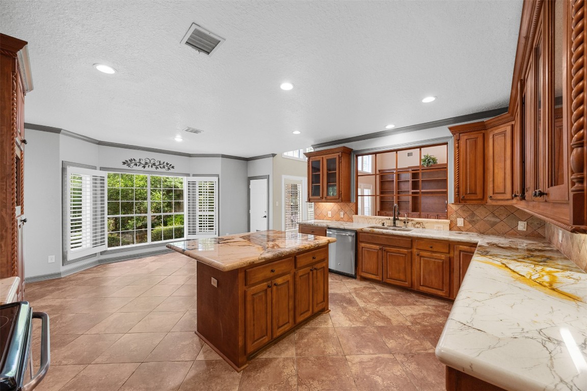 2622 Muegge Road Rosenberg, TX 77471 - Photo 10 of 35 a large kitchen with kitchen island granite countertop a large window and a counter space