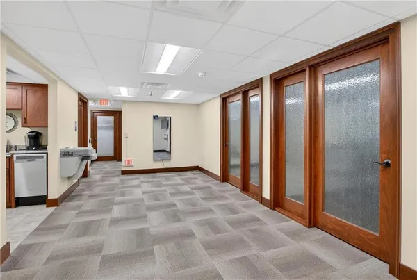 a view of a hallway with closet and a window