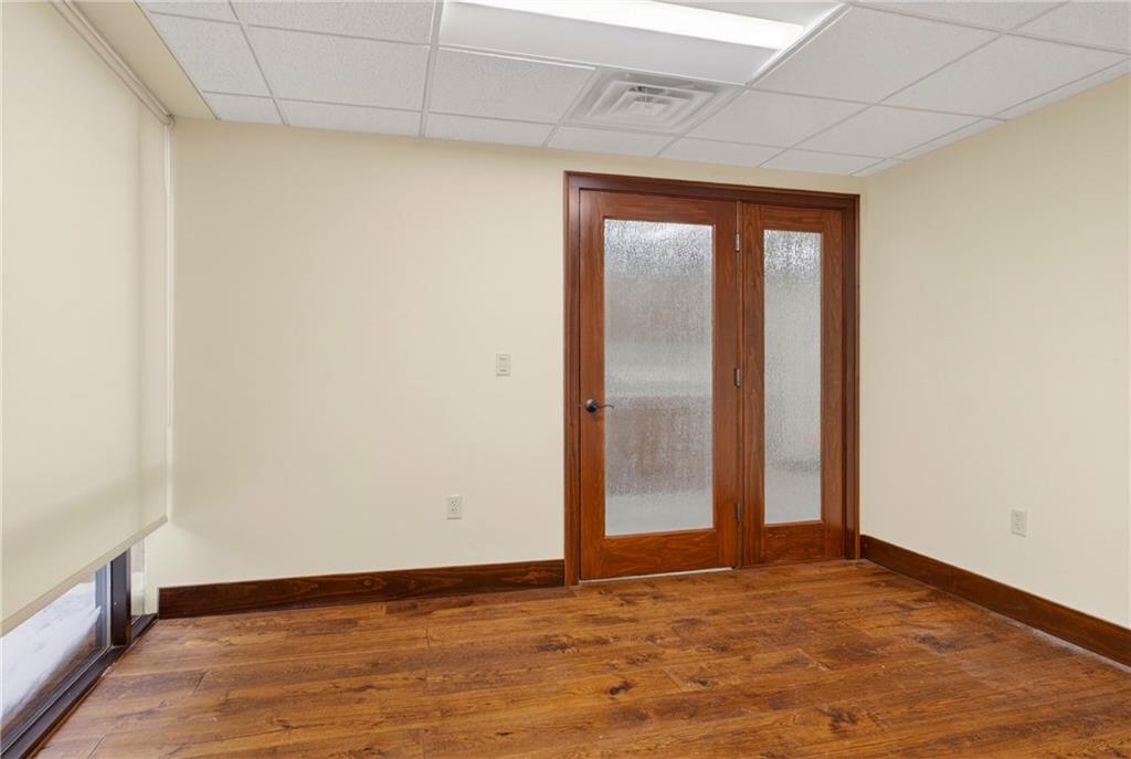 750 Washington Road Pittsburgh, PA 15228 - Photo 39 of 45 a view of an empty room with wooden floor and a window