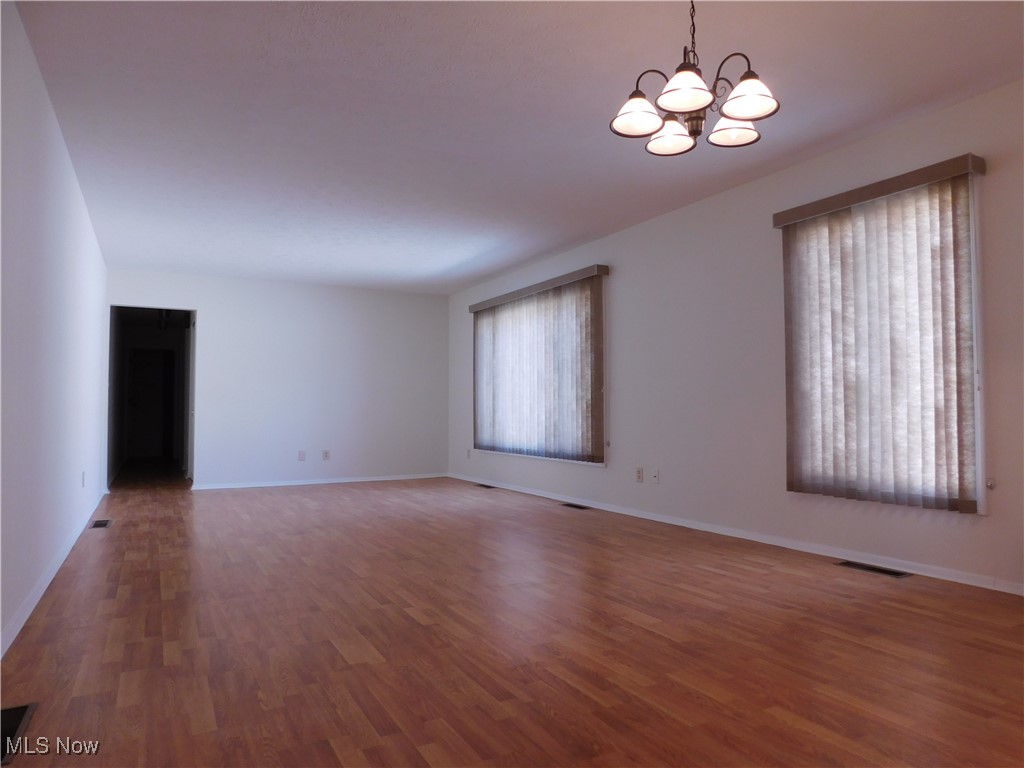 32885 Mills Road North Ridgeville, OH 44039 - Photo 16 of 42 Great room with a chandelier over the dining area and laminate wood finished floors