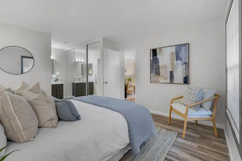 a bathroom with a double vanity sink a toilet and a mirror