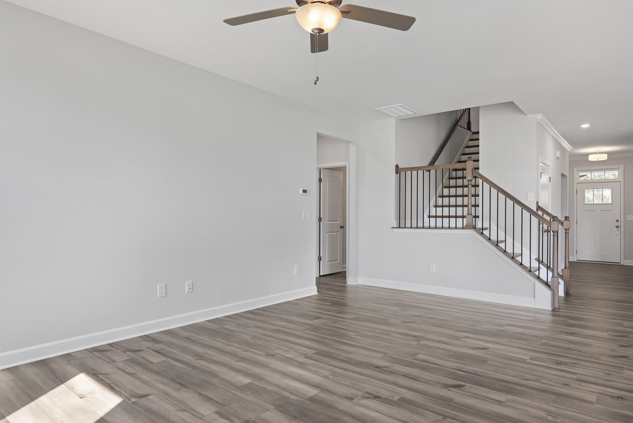 82 Morningside Lane Angier, NC 27501 - Photo 12 of 28 a view of an empty room with wooden floor and a chandelier fan