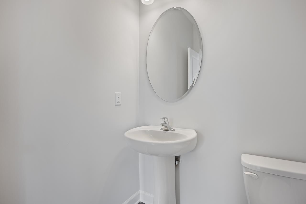 82 Morningside Lane Angier, NC 27501 - Photo 14 of 28 a bathroom with a sink and a mirror