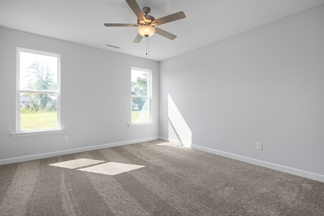 82 Morningside Lane Angier, NC 27501 - Photo 15 of 28 an empty room with windows and fan