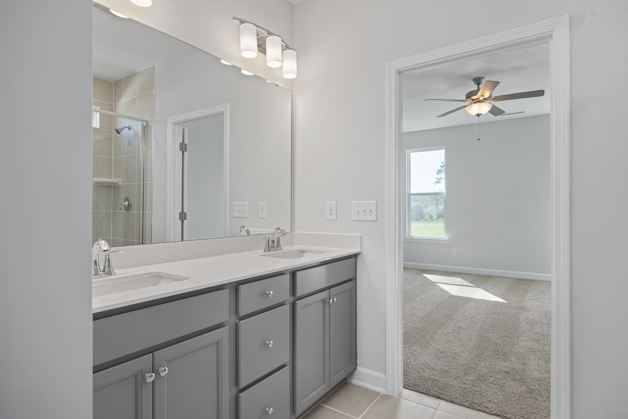 82 Morningside Lane Angier, NC 27501 - Photo 18 of 28 a bathroom with a double vanity sink and a mirror