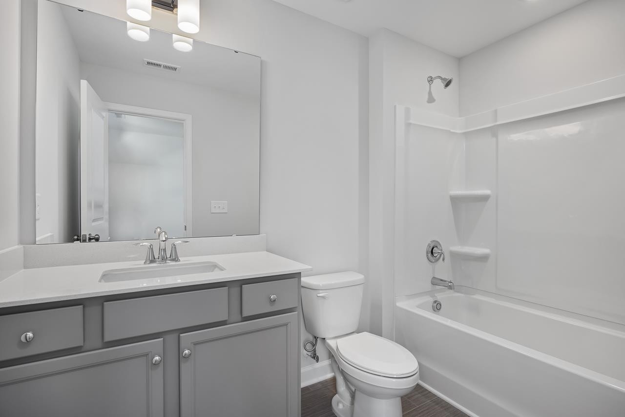 82 Morningside Lane Angier, NC 27501 - Photo 24 of 28 a bathroom with a sink a toilet and a mirror