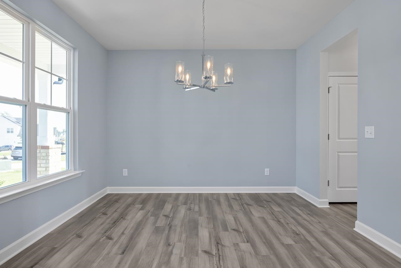 82 Morningside Lane Angier, NC 27501 - Photo 3 of 28 a view of a room with wooden floor and windows