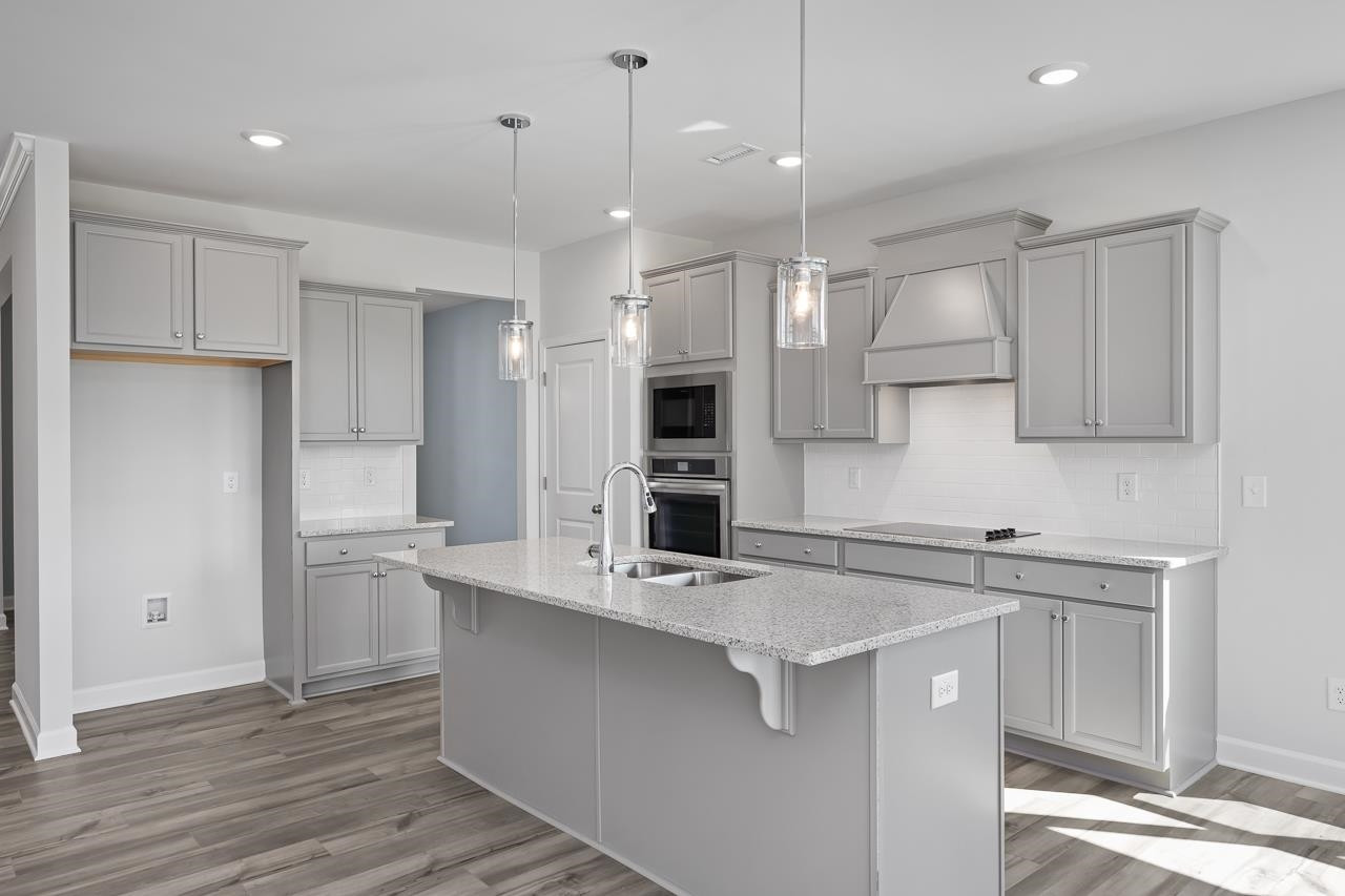 82 Morningside Lane Angier, NC 27501 - Photo 7 of 28 a kitchen with kitchen island a sink stainless steel appliances and cabinets