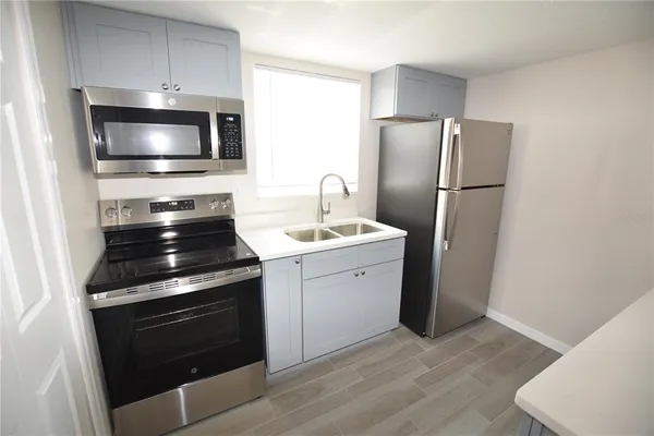 a kitchen with a stove and a microwave