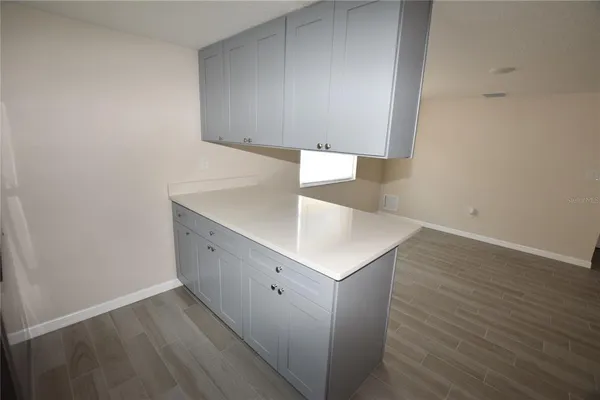 a view of an empty room with wooden floor