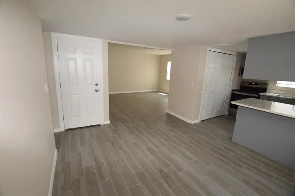 a view of a kitchen with wooden floor and a sink