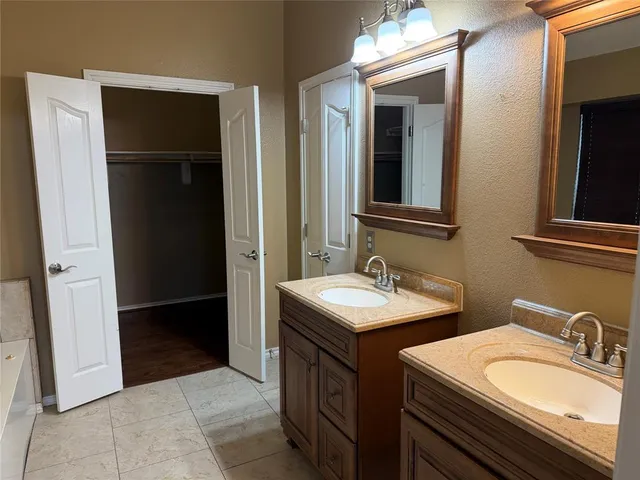 a bathroom with 2 sink and a mirror