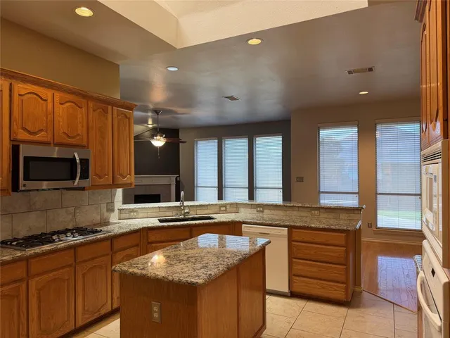 a kitchen with granite countertop stainless steel appliances and cabinets