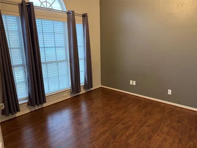 a view of a room with wooden floor and fence