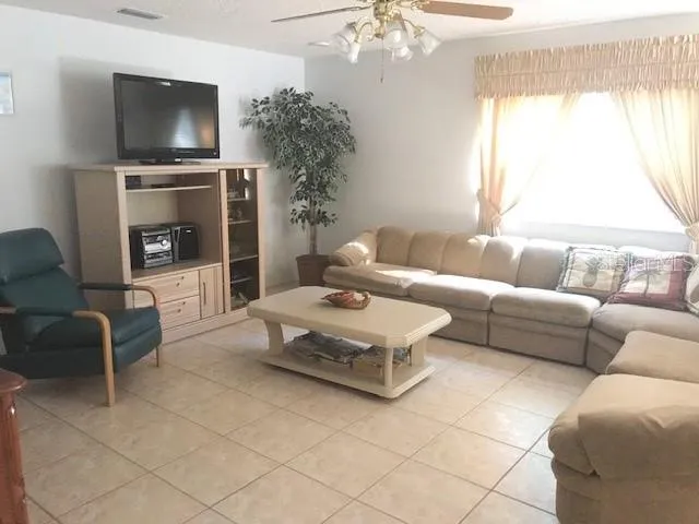 a bedroom with a bed and a potted plant