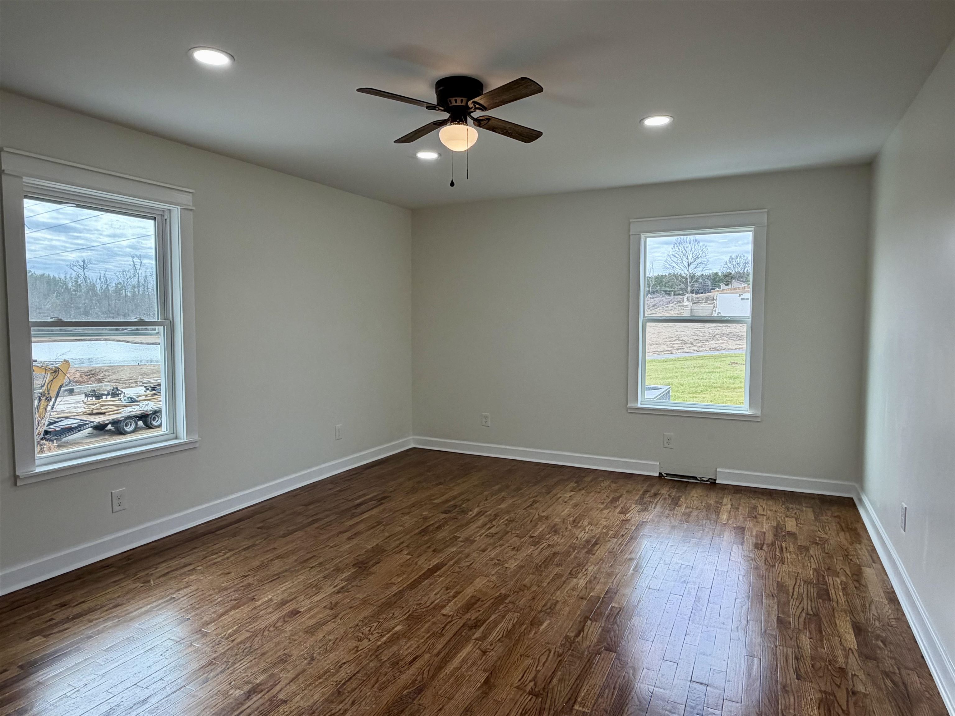 172 New Bethel Road Selmer, TN 38375 - Photo 20 of 30 an empty room with wooden floor chandelier and windows