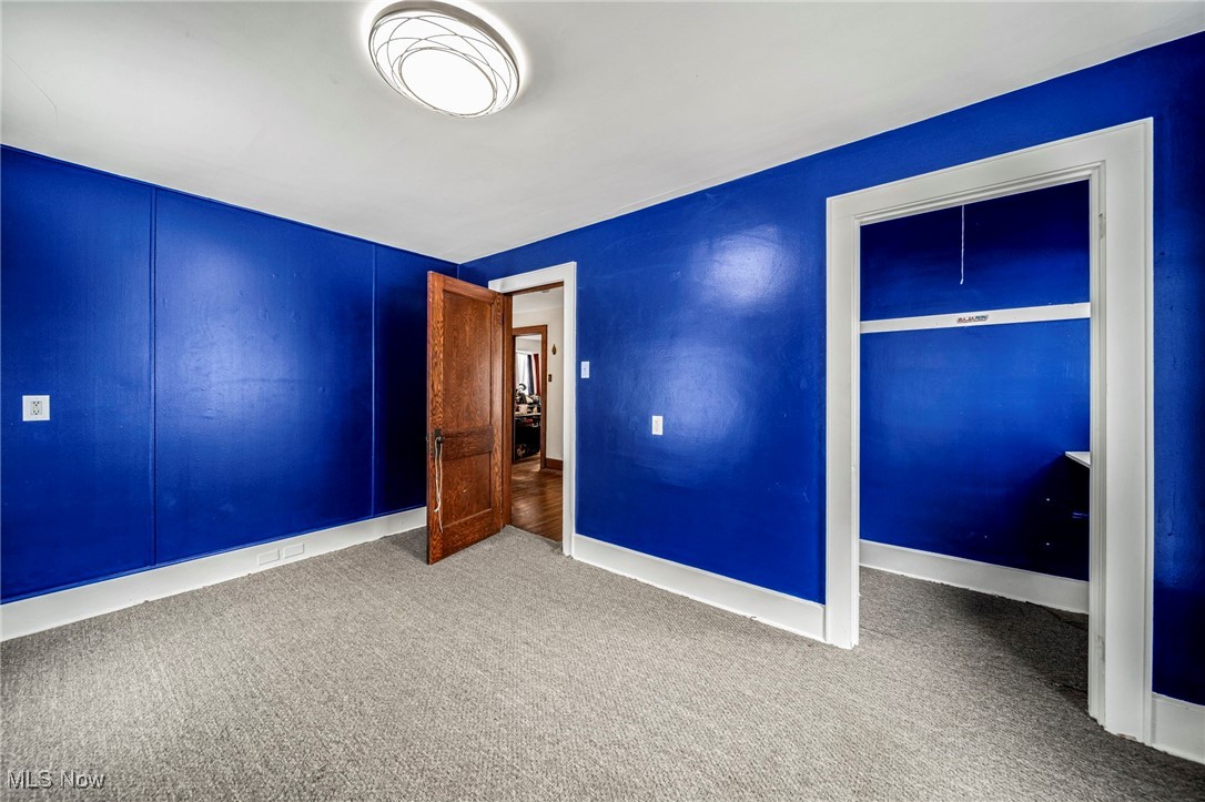 977 West Prospect Road Ashtabula, OH 44004 - Photo 29 of 42 Unfurnished bedroom featuring carpet floors and a closet