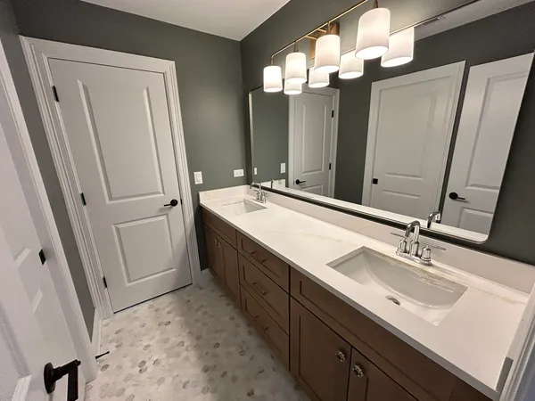 a bathroom with a double vanity sink and a mirror