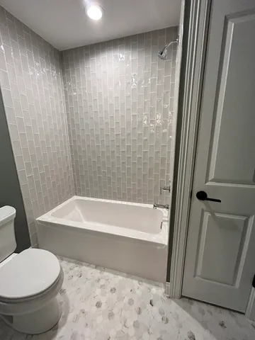 a bathroom with a toilet and a bathtub