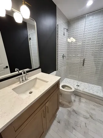 a bathroom with a sink a toilet and mirror