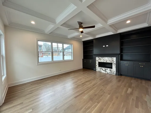 a view of an empty room with a fireplace and a window