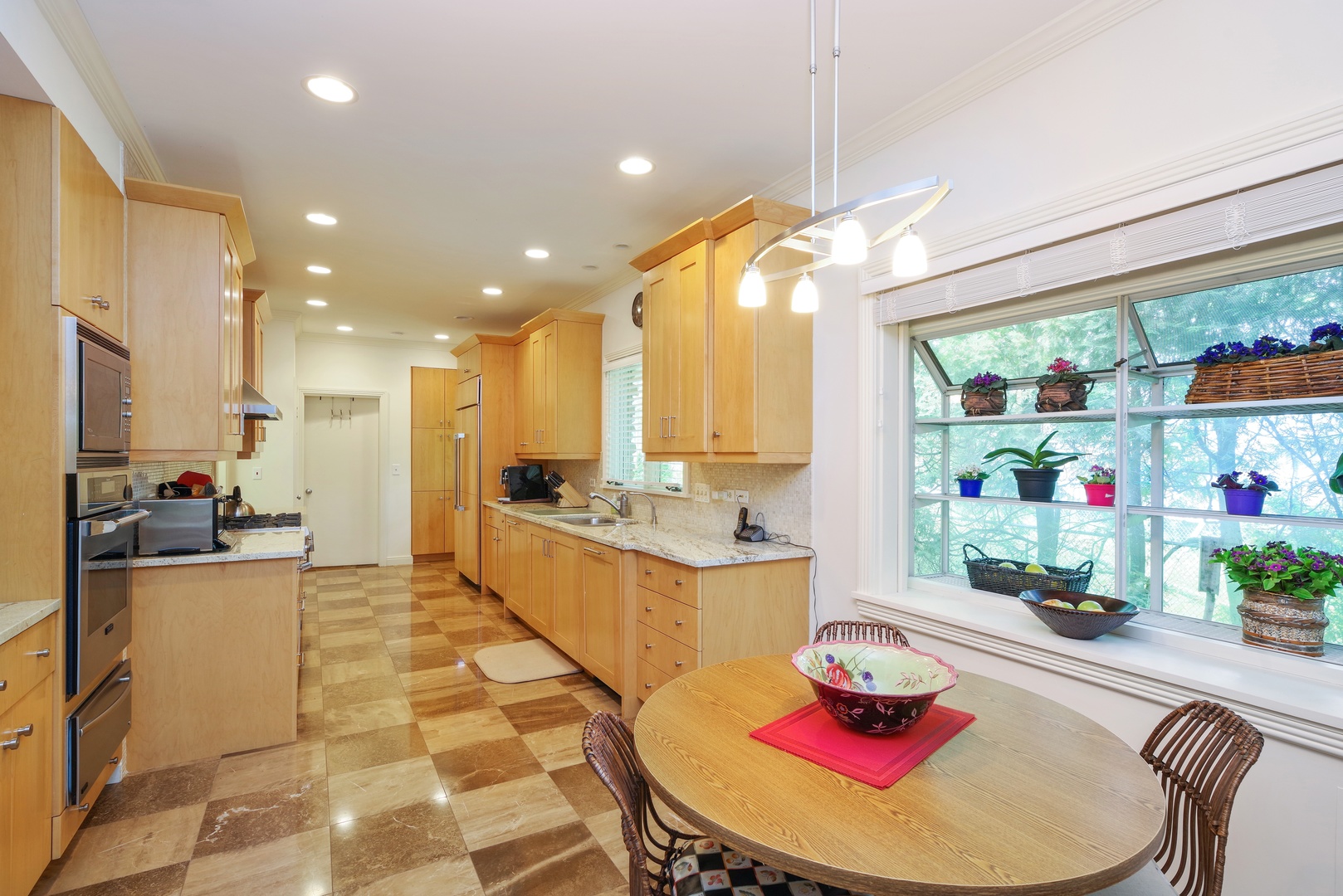 129 Beach Road Glencoe, IL 60022 - Photo 3 of 10 a kitchen with stainless steel appliances kitchen island granite countertop lots of refrigerator