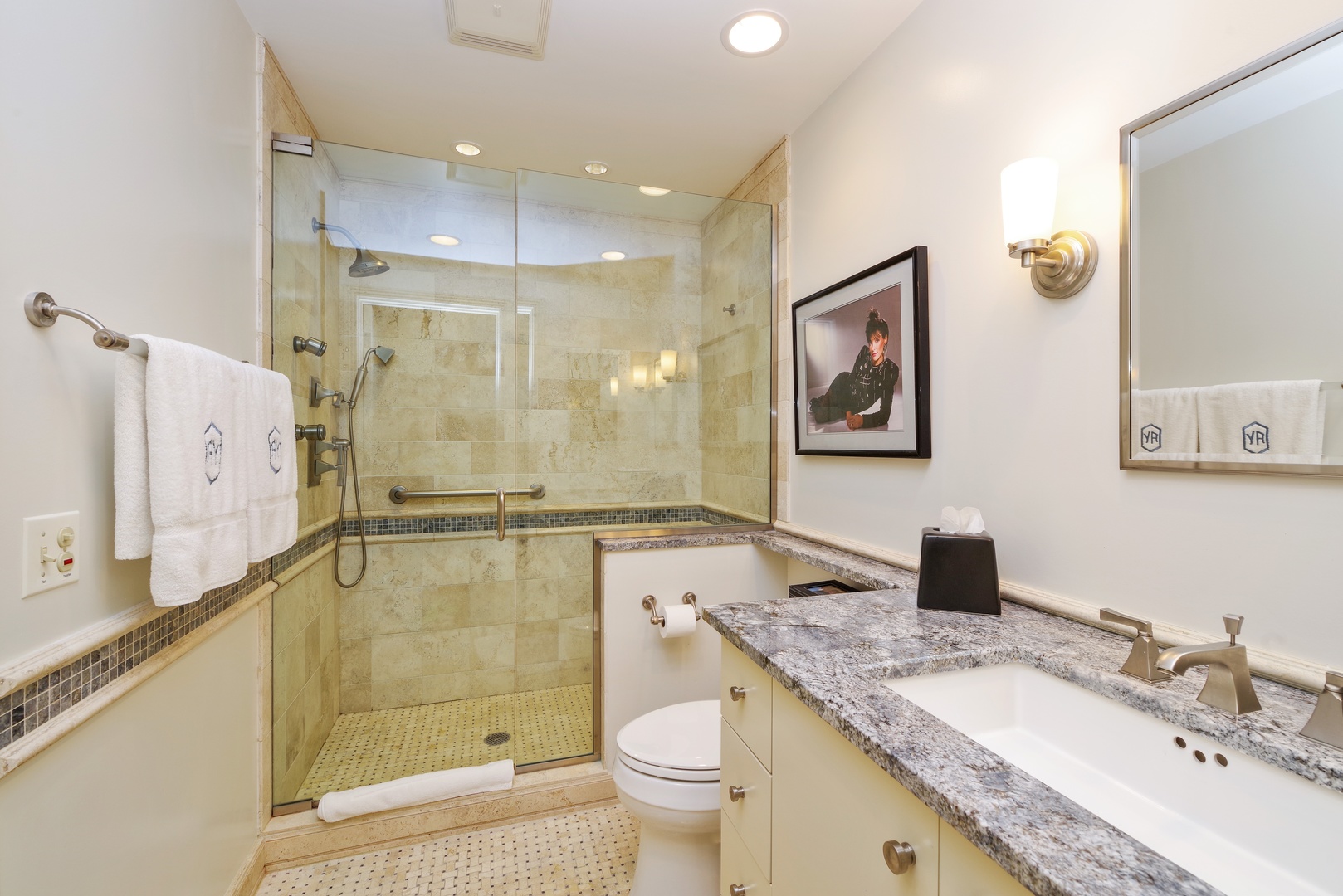 129 Beach Road Glencoe, IL 60022 - Photo 8 of 10 a bathroom with a granite countertop sink a toilet a mirror a shower and bathtub