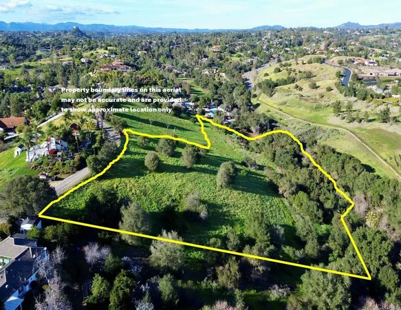 an aerial view of a residential houses with outdoor space and swimming pool