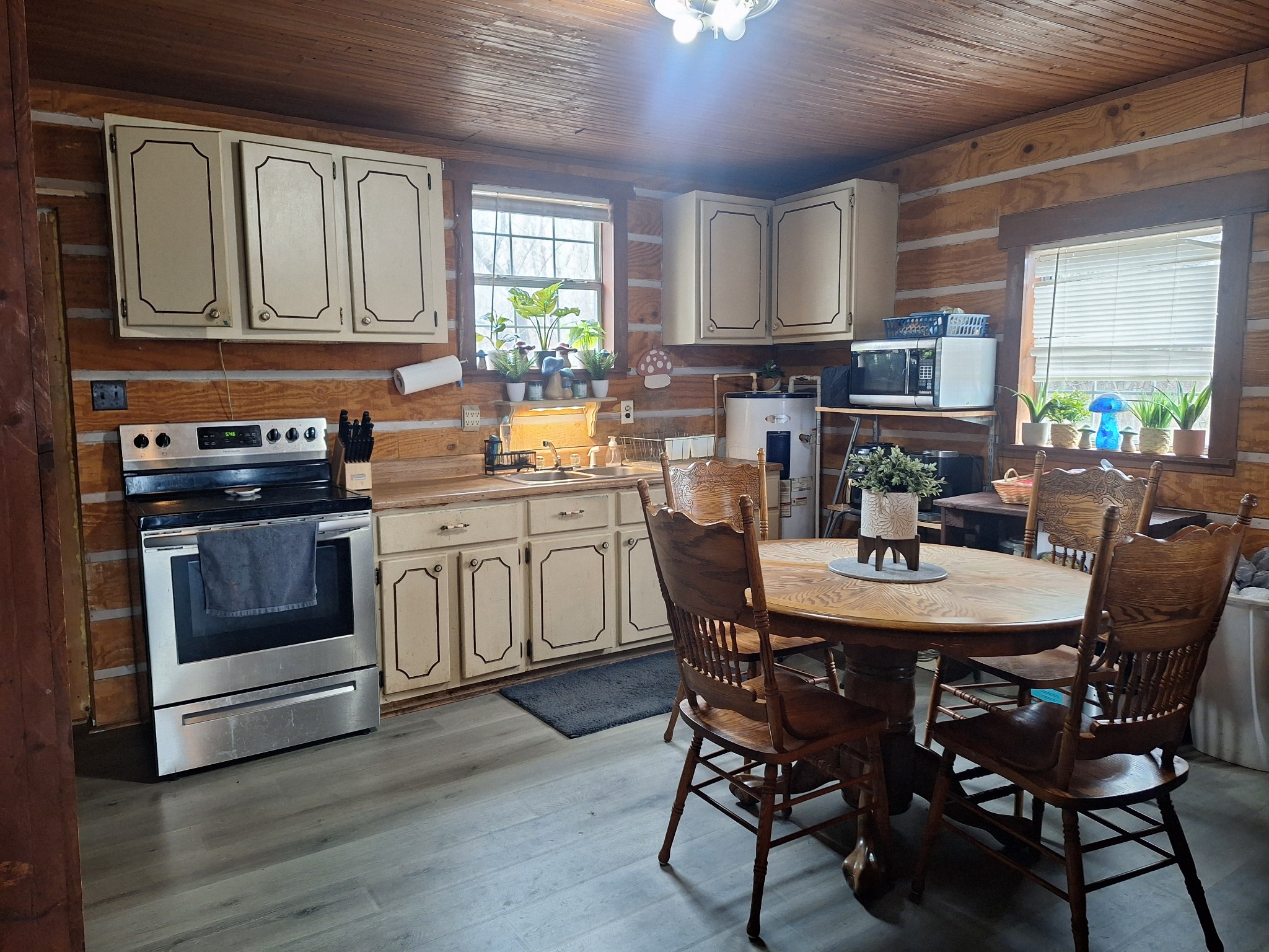 199 Dixon Ln. Waynesboro, TN 38485 - Photo 7 of 52 a view of a kitchen with a dining table chairs wooden cabinets and stainless steel appliances