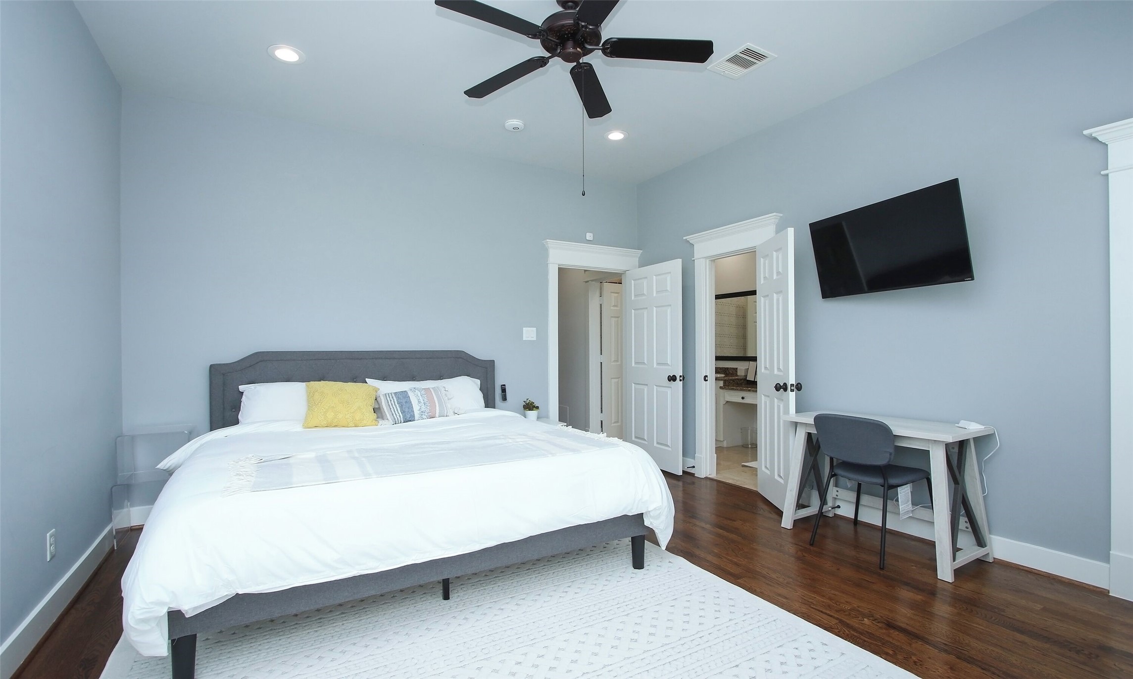 1330 West 25th Street, Unit C Houston, TX 77008 - Photo 23 of 30 a bedroom with a bed a table and chair