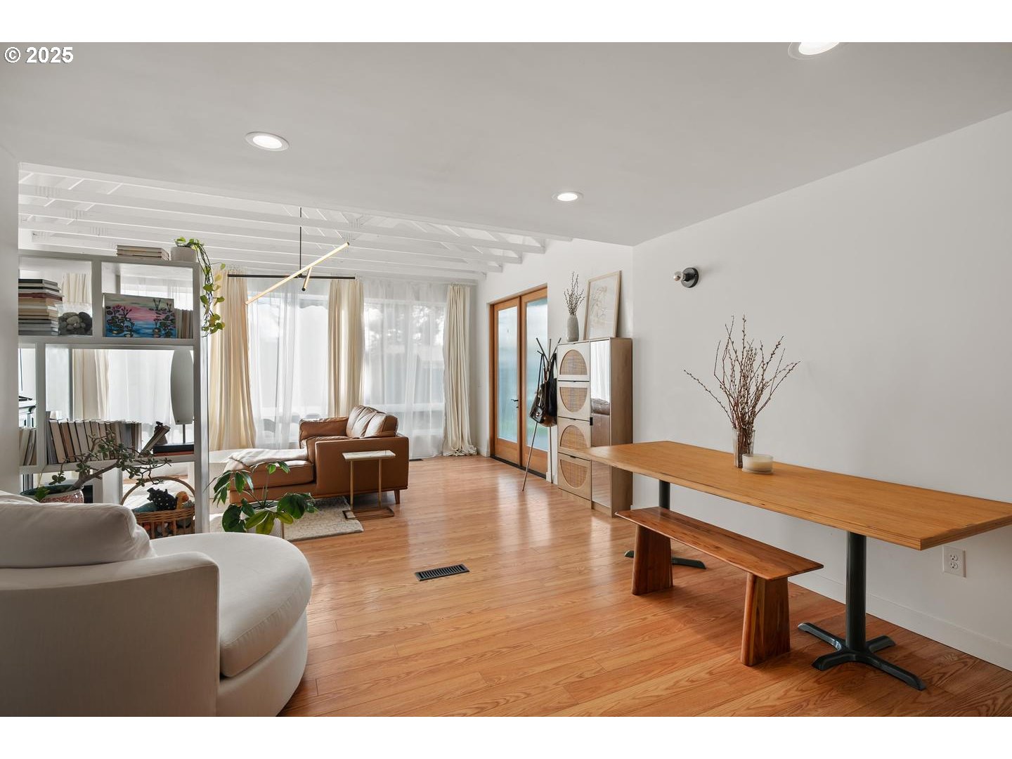 8629 Northeast Clackamas Street Portland, OR 97220 - Photo 11 of 32 a living room with furniture a wooden floor and a large window