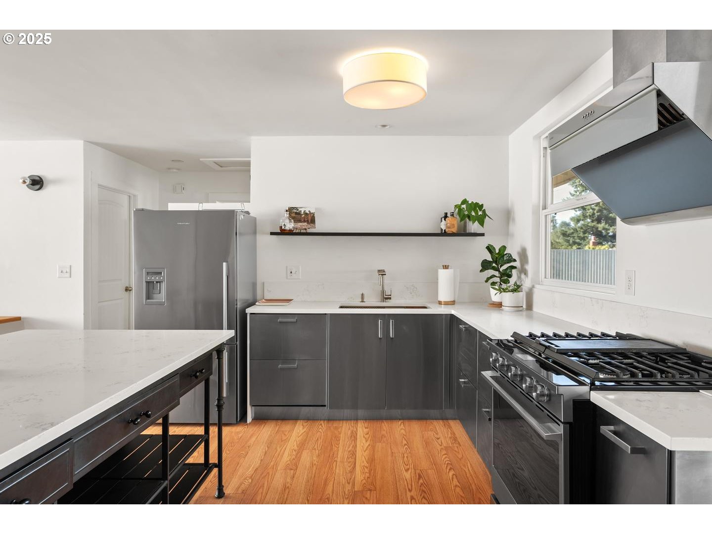 8629 Northeast Clackamas Street Portland, OR 97220 - Photo 16 of 32 a kitchen with stainless steel appliances a stove a sink and a refrigerator