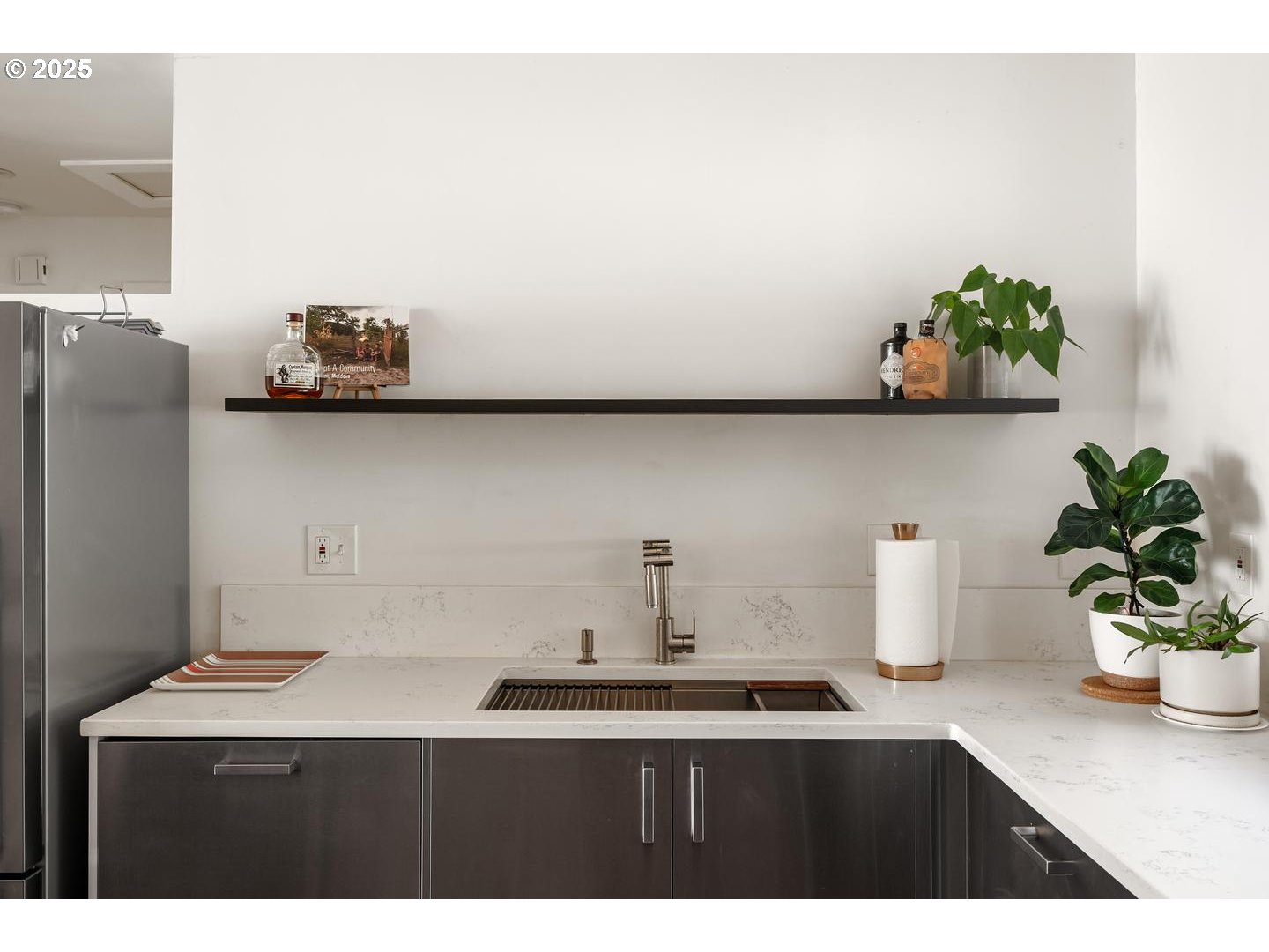8629 Northeast Clackamas Street Portland, OR 97220 - Photo 19 of 32 a kitchen with a sink a potted plant and wooden floor