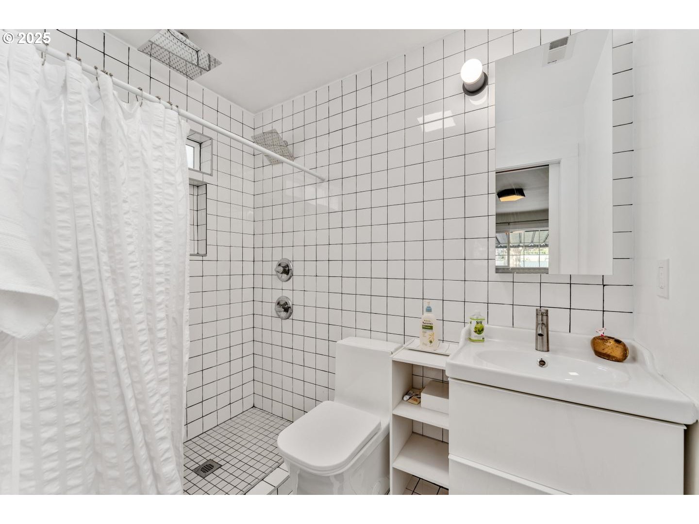 8629 Northeast Clackamas Street Portland, OR 97220 - Photo 21 of 32 a bathroom with a sink mirror vanity and toilet