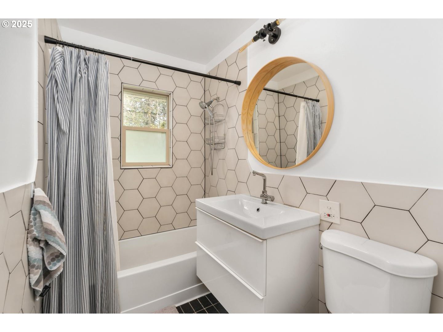 8629 Northeast Clackamas Street Portland, OR 97220 - Photo 23 of 32 a bathroom with a sink a mirror a toilet and a window