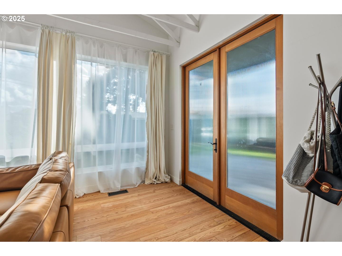 8629 Northeast Clackamas Street Portland, OR 97220 - Photo 6 of 32 a view of empty room with wooden floor and fan