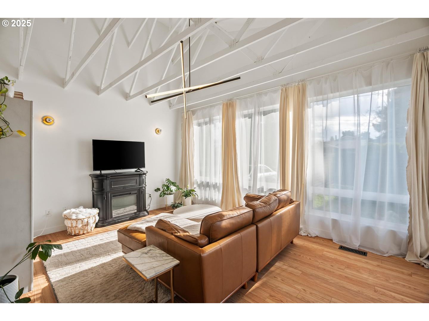 8629 Northeast Clackamas Street Portland, OR 97220 - Photo 7 of 32 a living room with furniture a flat screen tv and a large window
