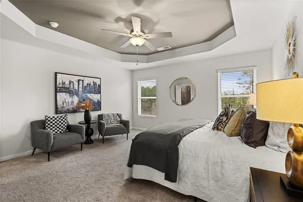 a bedroom with a bed and a large window