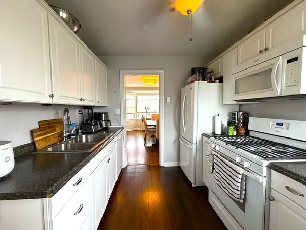 a kitchen with stainless steel appliances granite countertop a sink a stove and a refrigerator