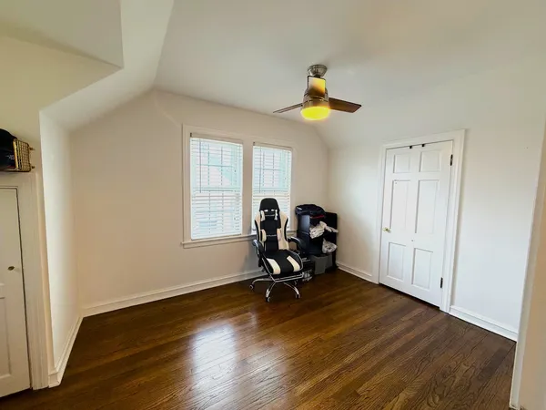a view of a room with gym equipment and wooden floor
