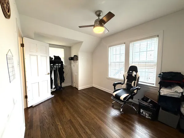 a view of a workspace with wooden floor and a window